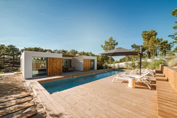 Foto op Canvas Modern house with garden swimming pool and wooden deck © Luis Viegas