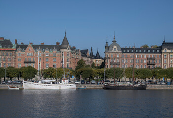 Fototapeta premium Water view with old wood boats and houses over the district Östermalm an autumn day in Stockholm