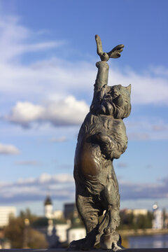 Vinnytsia, Ukraine -  14 October, 2020. Bronze sculpture of a cat with a butterfly on the Kiev bridge in Vinnitsa. Sculpture of an animal on the bridge over the Pivdennyi Buh River