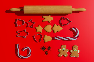 Christmas food. Homemade gingerbread cookies with ingredients for christmas baking and kitchen utensils on red table. 3D Illustration
