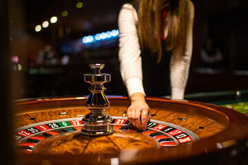 The croupier holds a roulette ball in his hand in a casino. Casino wheel.
