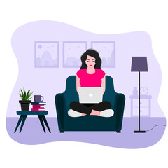 a young girl sits at home in an armchair, works at a laptop. Freelance concept