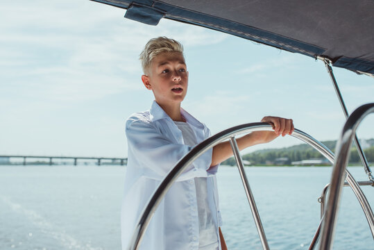handsome Caucasian boy on the yacht 