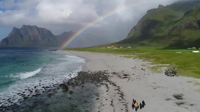 flight over rainbow over the beach in seashore at the foot of the magn