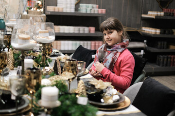 Girl with glass and decoration of Christmas table, xmas concept.
