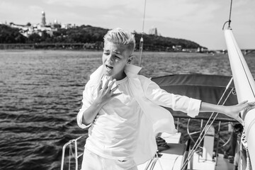 Obraz premium singing, blonde, blue, boat, boy, caucasian, crew, cruise, cute, education, fashion, fun, handsome, happy, leisure, lifestyle, male, marina, marine, nautical, navigator, outdoor, portrait, river, sail