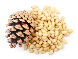 Heap of pine nuts and pine cone on white background, isolated. The view from top