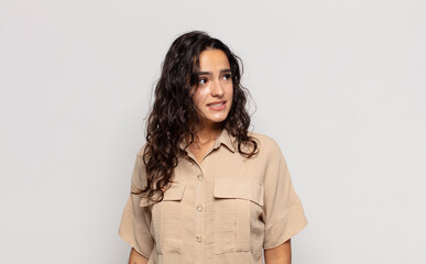 pretty young woman looking worried, stressed, anxious and scared, panicking and clenching teeth