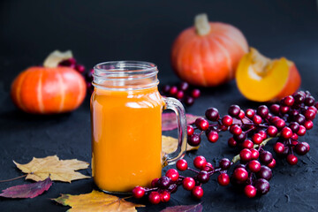 Halloween cocktail, pumpkin orange drink with spices. Dark vintage dirty background. Creative atmospheric decoration