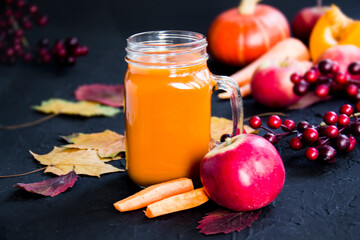 Halloween cocktail, pumpkin orange drink with spices. Dark vintage dirty background. Creative atmospheric decoration