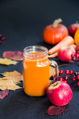 Halloween cocktail, pumpkin orange drink with spices. Dark vintage dirty background. Creative atmospheric decoration