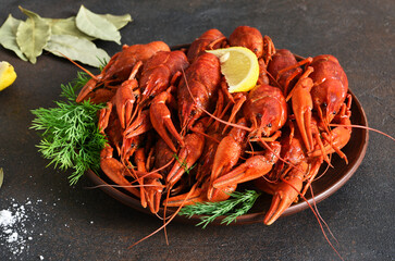 Red crayfish with dill, bay leaf and lemon in a plate.