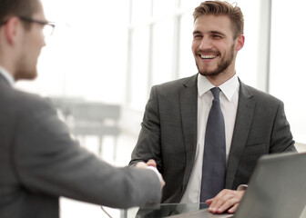 close up.smiling business people shaking hands in office