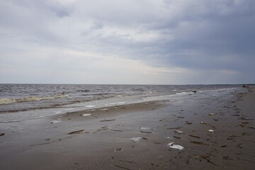 White sea beach on cloudy spring day