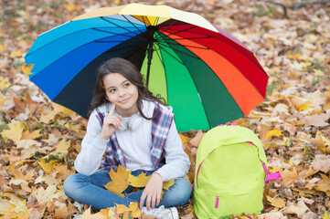 happy kid in casual style spend time relaxing in autumn park enjoying good weather under colorful...