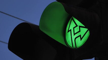 Close-up of a green traffic light indicating the direction of travel. Traffic light lens. - Powered by Adobe