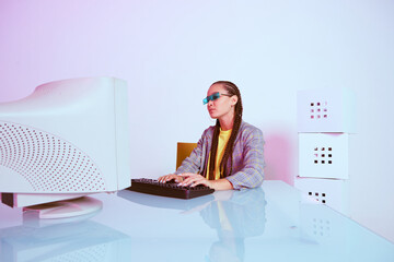 Stylish asian female office worker or hacker in sunglasses typing at obsolete computer. Colored...