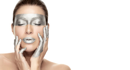 Silver skincare treatment concept. Beautiful young woman with silver mask