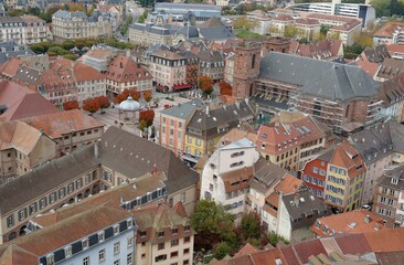 Rooftops of the old city of Belfort. Aerial view of the historic houses and buildings arranged densely to each other. View from the citadel or fortress surrounding the city.