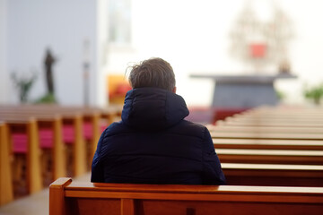 Religious middle age man praying and meditating in catholic church. Person begging for forgiveness...