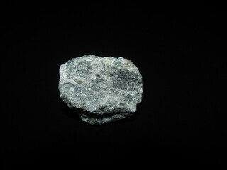 a sample of the granular Apatite stone on a black background