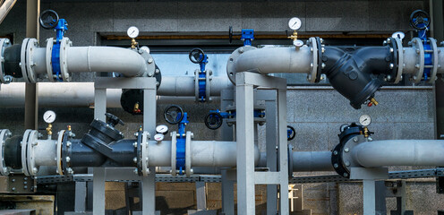Pipe system with valves and pressure gauges outside the building.