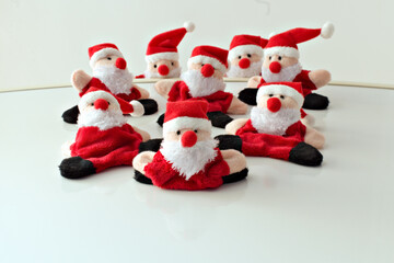 funny santa claus toys roll down the white mountain focus on foreground