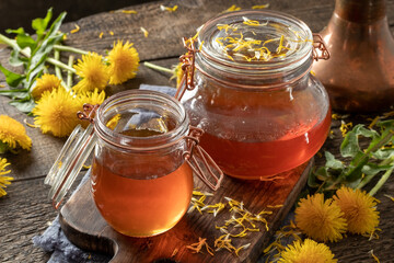 Dandelion honey with fresh dandelion flowers