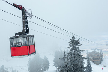 A gondola in the middle of the mountains. Winter travel concept.