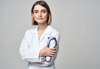 Woman in white coat doctor and stethoscope in hand