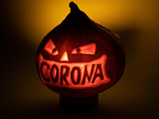 Halloween pumpkin with corona lettering glowing in the dark