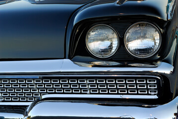 Obraz na płótnie Canvas Headlights and grill of a black 1959 Meteor Montcalm made in Canada