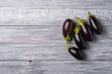Fresh ripe eggplant on grey wooded backdrop background, top view copy space