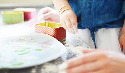 children's hands in flour on the table