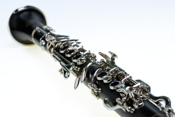 Close up of keywork and bell of a clarinet on a white background