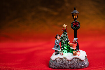 Christmas decoration - figure with two children on red background