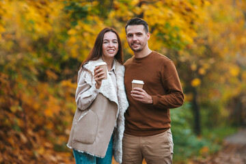 Fototapeta premium Happy family walking in autumn park on sunny fall day