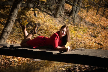 The girl in the red dress. Autumn park.