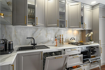 Closeup details of grey and white modern classic kitchen, all doors are open
