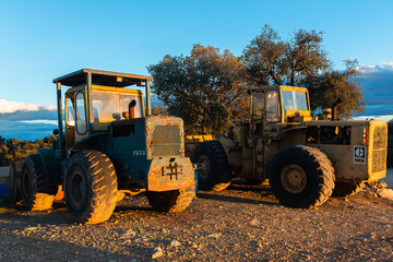 Old tractors with sunset light reflection