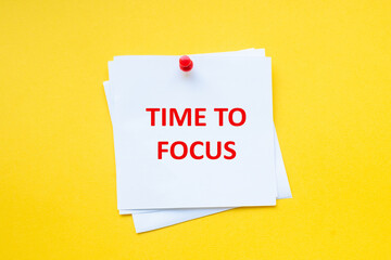 Time to focus. Motivational slogan on white sticker with yellow background