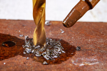 Drilling in metal with a tool steel drill bit. Minor locksmith work in the workshop.