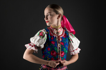 portrait of the beautiful young woman in traditional slovak folk dress