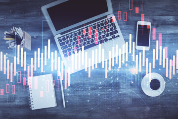 Double exposure of forex chart drawing over table background with computer. Concept of financial research and analysis. Top view.