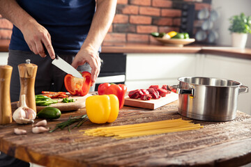 Man preparing delicious and healthy food in the home kitchen