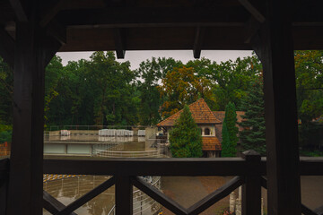 fall season landmark view from wooden balcony on medieval tower fortress building in park outdoor environment space October moody day
