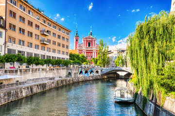 Ljubljana City Center during a Sunny Day overlooking Lublanka river and Beautiful Franciscan Church