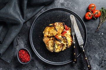 Vegetable ratatouille on a plate. French Provencal casserole. Black background. Top view