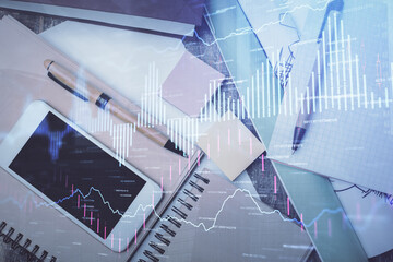 Multi exposure of forex graph hologram over desktop with phone. Top view. Mobile trade platform...