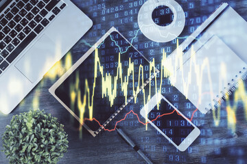 Double exposure of forex chart hologram over desktop with phone. Top view. Mobile trade platform concept.